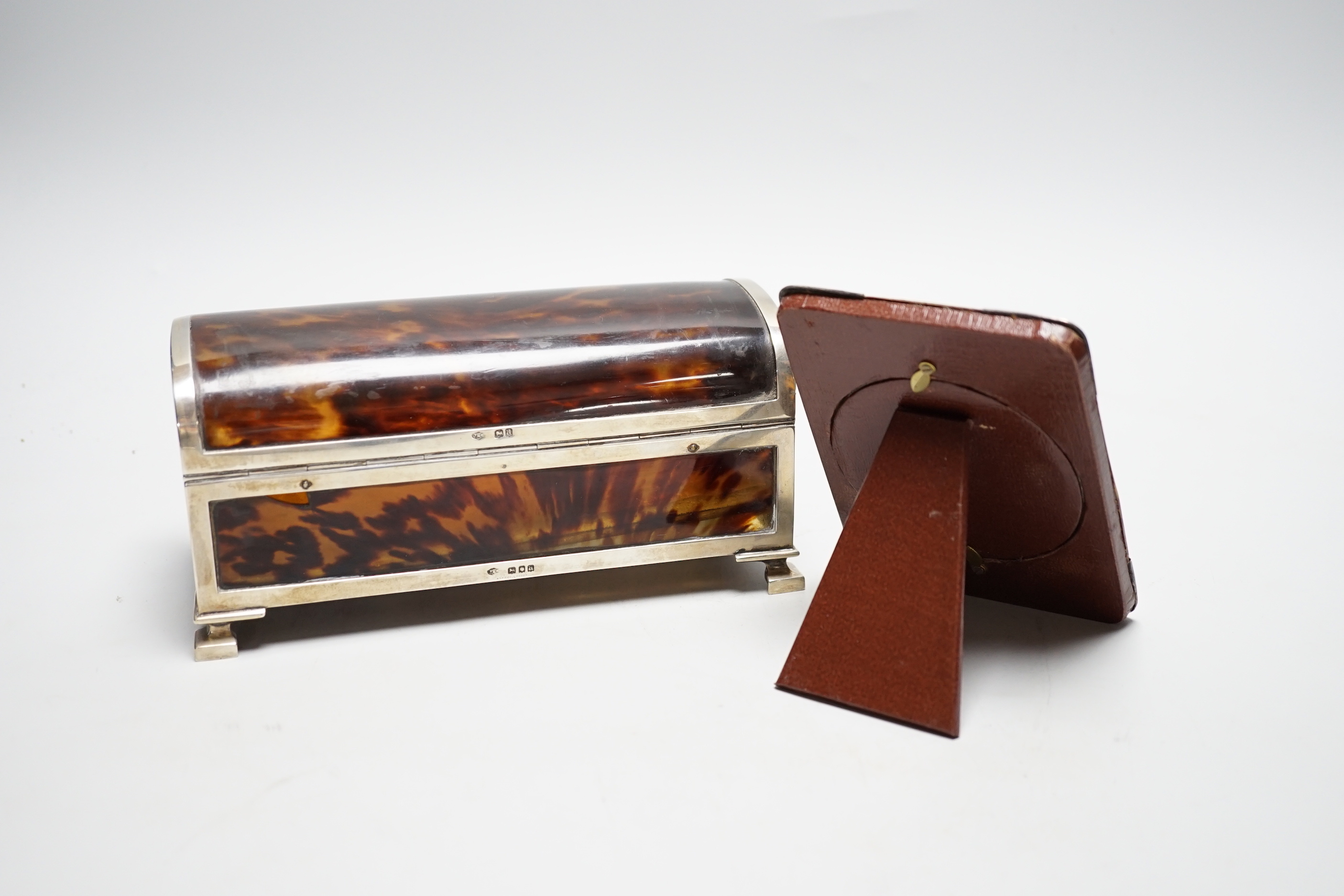 A George V silver mounted tortoiseshell domed top jewellery casket (a.f.) J.Batson & Sons, London, 1916, retailed by Asprey, London, 19.6cm, together with a small Edwardian silver mounted tortoiseshell photograph frame.